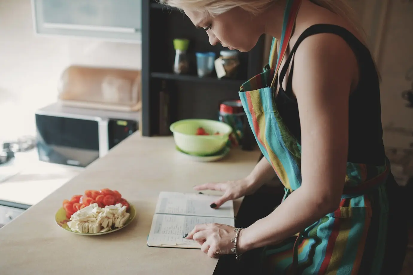 Young woman consulting a recipe book