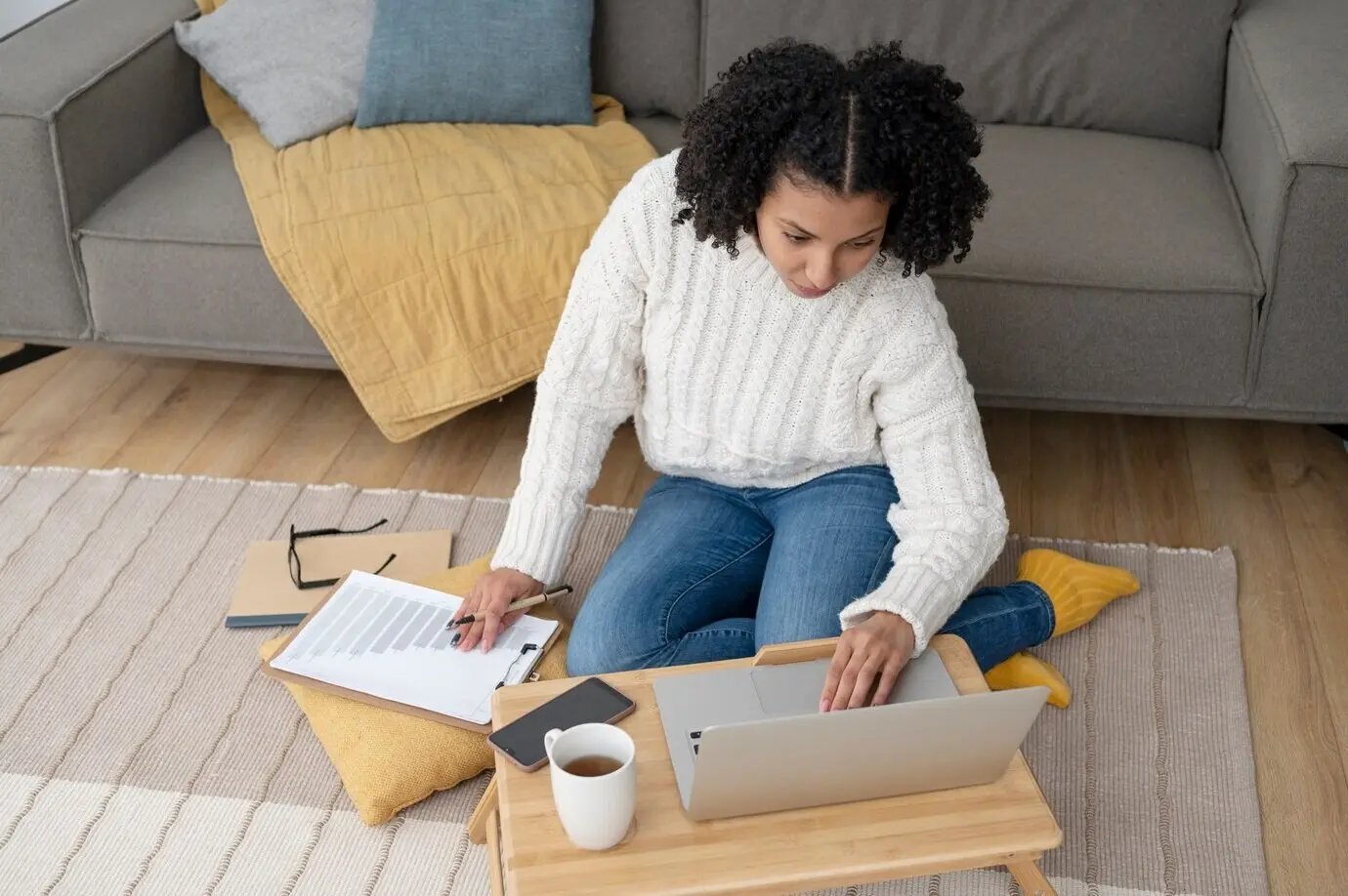 Full shot of a woman typing on a laptop